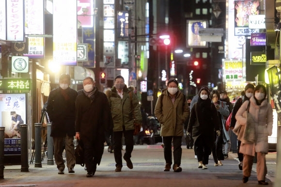 도쿄 시민들이 마스크를 쓴 채 술집과 음식점들이 줄지어 들어선 거리를 따라 걷고 있는 모습/사진=도쿄 AP 연합뉴스