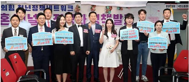 김기현 국민의힘 당 대표가 11일 오전 서울 여의도 국민의힘 당사에서 열린 '국민의힘 청년정책네트워크 결혼 페널티 정상화 정책 발표'에서 예비 신혼부부 등 참석자와 퍼포먼스를 하고 있다. 뉴시스