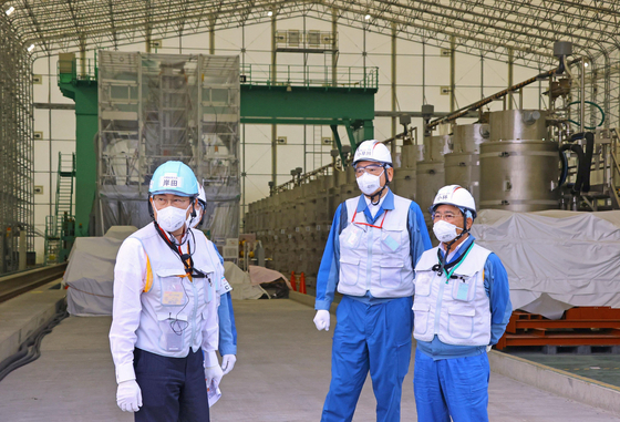 In this photo released by Kyodo News Agency, Japanese Prime Minister Fumio Kishida, left, inspects a water treatment facility at the crippled Fukushima Daiichi nuclear power plant in northeastern Japan. [REUTERS]