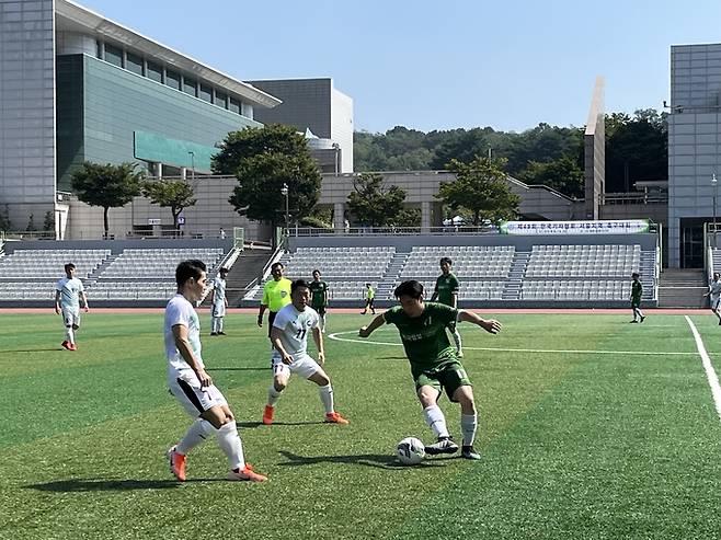 9일 고양 어울림누리 별무리경기장에서 열린 축구대회 예선 경기에서 조선일보(하얀색)와 한국일보(초록색) 선수들이 볼 경합을 하고 있다. (김고은 기자)