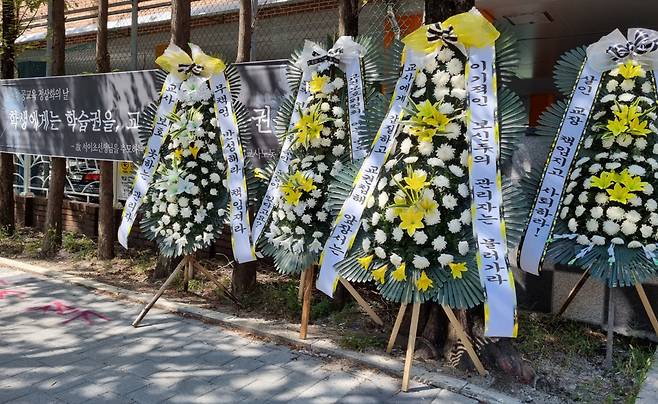 10일 오전 대전 서구 모 초등학교 정문 앞에 학부모의 악성 민원에 시달리다 극단적 선택을 한 대전 초등학교 교사가 당시 근무했던 학교 교장 앞으로 항의성 근조화환이 쇄도하고 있다. 숨진 교사가 초등교사노조에 제보한 내용에 따르면 2019년 1학년 담임을 맡았을 당시 친구를 괴롭히는 학생 행동을 지도하다 불거진 학부모의 악성 민원 때문에 학교에 교권보호위원회를 열어달라고 요청했으나 받아들여지지 않았고, 당시 교장과 교감 선생님으로부터 어떠한 도움도 받지 못한 것으로 나타났다. [연합뉴스]