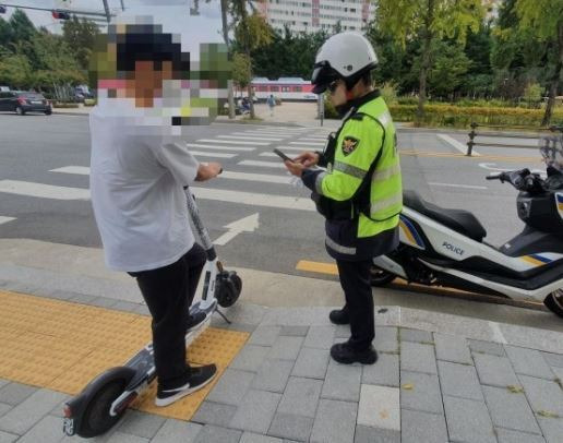 노원경찰서 교통경찰관이 전동킥보드 이용자의 법규위반행위를 단속하고 있다. (위 기사와 무관합니다.)/사진=연합뉴스