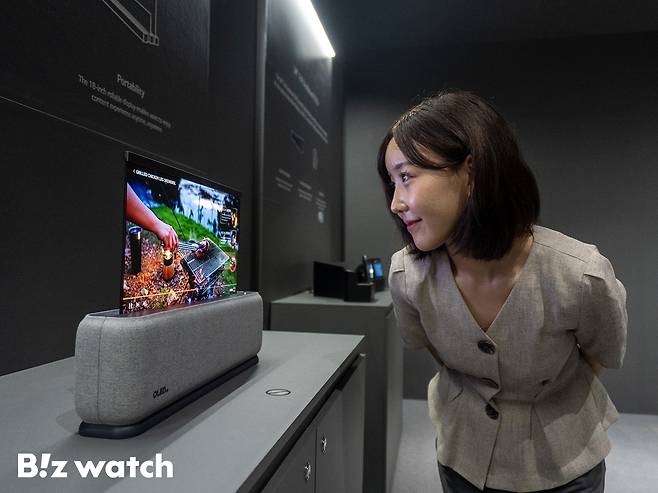 ‘IMID 2023'에서 관람객이 LG디스플레이의 18인치 차량용 롤러블 OLED 패널을 살펴보고 있다./사진=LG디스플레이