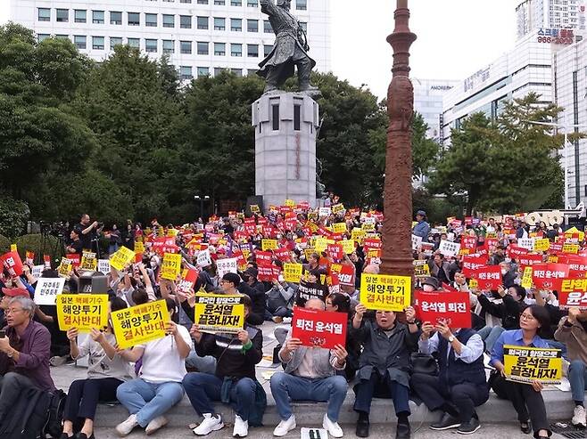 9일 부산 동구 초량동 일본영사관 앞 정발 장군 동상 앞에서 열린 시국기도회에서 참석자들이 손팻말을 들며 노래를 부르고 있다. 김광수 기자