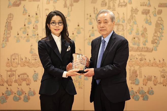김건희 여사가 12일 서울 용산 대통령실 청사에서 열린 대한암협회 명예회장 추대행사에서 이민혁 대한암협회 회장으로부터 추대패를 받은 뒤 기념촬영을 하고 있다. 대통령실 제공