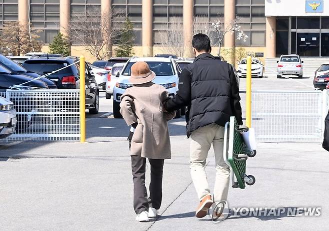 경찰서 나서는 급발진 의심 사고 할머니 (강릉=연합뉴스) 지난해 12월 강릉에서 차량 급발진 의심 사고로 12살 손자를 잃고, 교통사고처리 특례법상 치사 혐의로 입건된 60대 할머니가 지난 3월 20일 첫 경찰조사를 마치고 아들의 부축을 받으며 경찰서를 떠나고 있는 모습. [연합뉴스 자료사진]