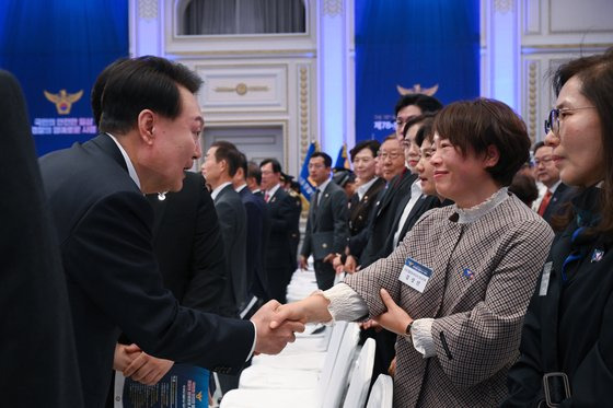 윤석열 대통령이 18일 청와대 영빈관에서 열린 제78주년 경찰의날 기념식에서 경찰영웅 고 이강석 경정의 배우자와 인사하며 격려하고 있다. 사진 대통령실