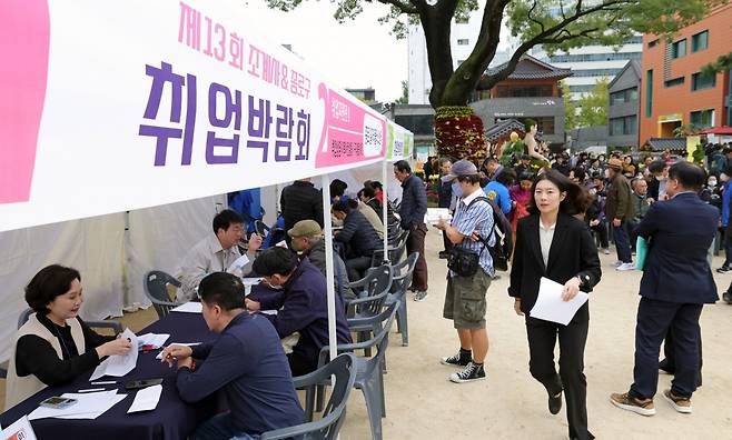 지난 25일 서울 수송동 조계사 대웅전 앞마당에서 열린 '종로구&조계사 취업박람회’ 모습. 노년 구직자들이 구직 상담을 받고 있다.  /한경DB