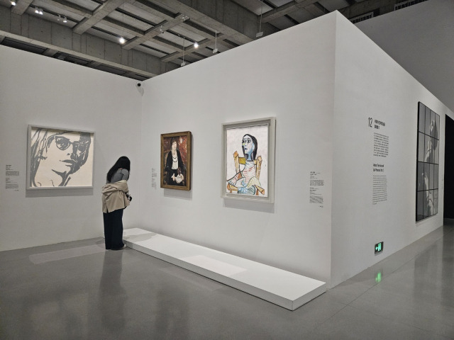 A visitor views masterpieces at the exhibition "Mirrors of the Portrait" at the West Bund Museum in Shanghai on Nov.9. (Park Yuna/Th Korea Herald)