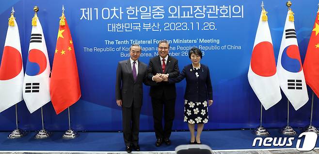 박진(가운데) 외교부 장관, 가미카와 요코(오른쪽) 일본 외무상, 왕이 중국 외교부장이 26일 오후 부산 해운대구 시그니엘 부산에서 열린 한일중 외교장관 회의에서 손을 맞잡고 기념촬영을 하고 있다. 2023.11.26/뉴스1 ⓒ News1 김명섭 기자