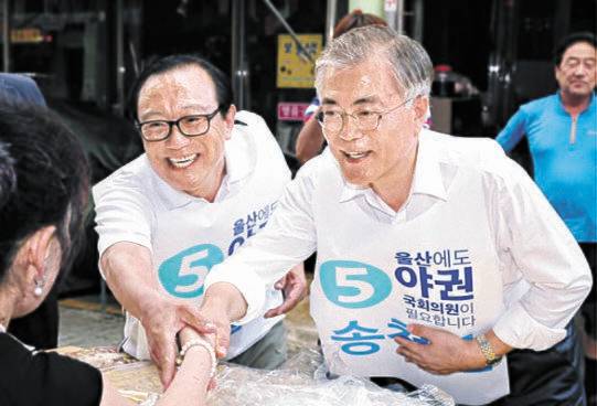 문재인 전 대통령이 국회의원 시절이었던 2014년 7월 울산 국회의원 보궐선거에 출마했던 송철호(왼쪽) 전 울산시장의 지지를 호소하며 함께 유세하는 모습. 문재인은 대통령 시절 송철호의 울산시장 당선을 '소원'이라 말했고, 결과적으로 울산시장 선거에 청와대가 개입해 송철호를 당선시킨 선거범죄가 이어졌다. [연합뉴스]