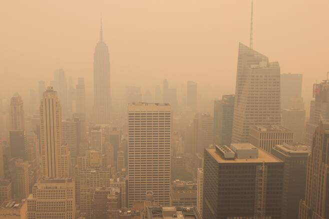 6월 7일(현지시간) 미국 뉴욕 맨해튼 스카이라인에 캐나다 산불로 인한 연무와 연기가 드리워진 가운데 록펠러센터 꼭대기에서 바라본 뉴욕의 모습./로이터 연합뉴스