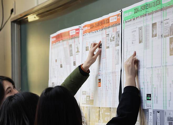 2024학년도 대학수학능력시험 성적표 배부일인 8일 오전 경기도 수원시 영통구 효원고등학교 3학년 교실에서 학생들이 대학 지원 참고표를 살펴보고 있다. 연합뉴스