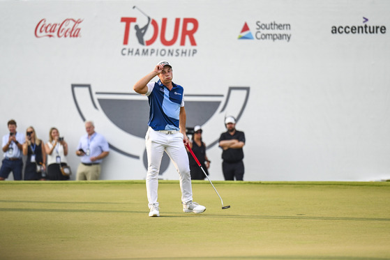 Viktor Hovland of Norway reacts after making a birdie putt on the 18th hole green to clinch a five stroke victory in the final round of the Tour Championship, the third and last event of the FedExCup Playoffs, at East Lake Golf Club on Aug. 27, 2023 in Atlanta, Georgia. [GETTY IMAGES]