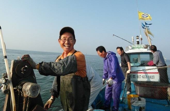2012년 6월3일 임봉택씨가 개야도를 방문한 진실의힘 사람들과 자신의 배 ‘성덕호’를 타고 바다로 나가 활짝 웃고 있다. 진실의힘 제공