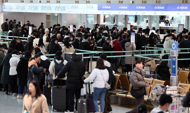 크리스마스 연휴가 시작된 22일 오전 인천국제공항 1터미널 출국장에서 일본으로 향하는 여행객들이 탑승 수속을 하고 있다.