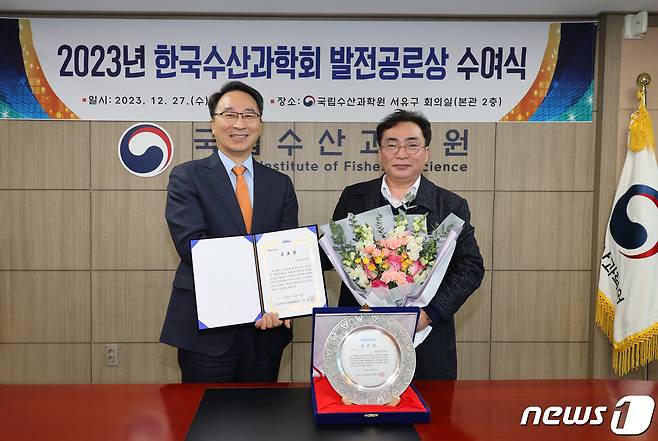 우동식 국립수산과학원장(왼쪽)이 공로상을 수상한 뒤 이정석 회장과 기념사진을 찍고 있다. (수과원 제공)