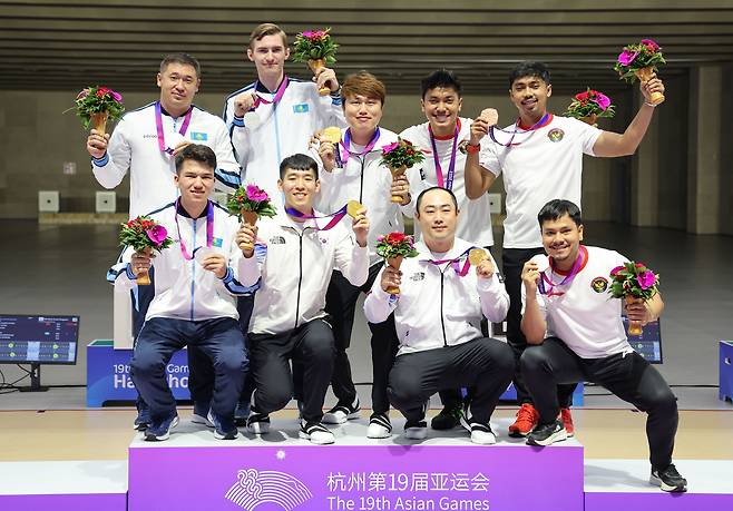 26일 중국 항저우 푸양 인후 스포츠센터에서 열린 제19회 항저우 아시안게임 남자 10ｍ 러닝타깃 혼합 단체전에서 금메달을 딴 한국 곽용빈, 정유진, 하광철이 은메달을 딴 카자흐스탄, 동메달을 딴 인도네시아 선수들과 기념 촬영하고 있다./연합뉴스