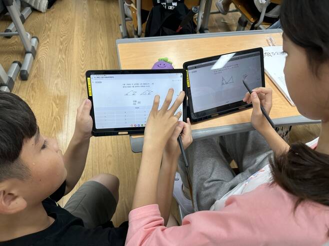 경북 모전초등학교 학생들이 AI 코스웨어를 활용해 수업 내용에 대해 이야기를 나누고 있다.[모전초 제공]