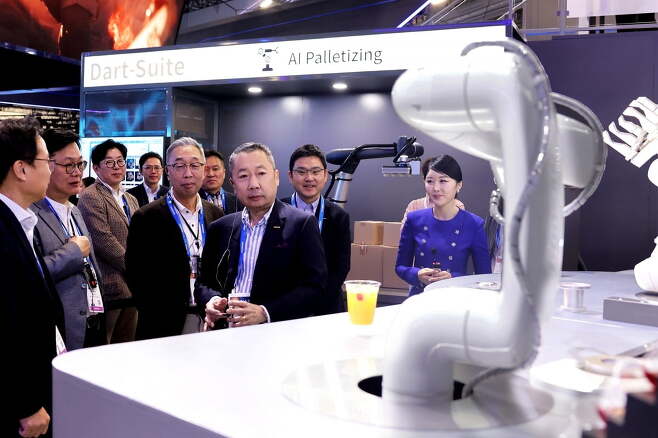 박정원 두산그룹 회장(가운데)과 박지원 그룹부회장(왼쪽)이 10일(현지 시간) CES 2024가 열리는 라스베이거스컨벤션센터를 찾아 두산 부스에서 AI칵테일 로봇을 살펴보고 있다. 사진=두산그룹