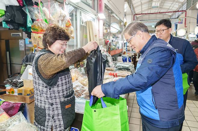 월성본부 김한성 본부장이 시장상인과 덕담을 나누며 장을 보고 있다. 월성원자력본부 제공