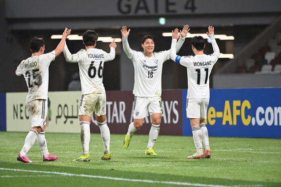 Ulsan HD's Joo Min-kyu, second from right, celebrates with his teammates during a 2023-24 AFC Champions League round of 16 match against Ventforet Kofu at JIT Recycle Ink Stadium in Japan on Wednesday. [AFC]