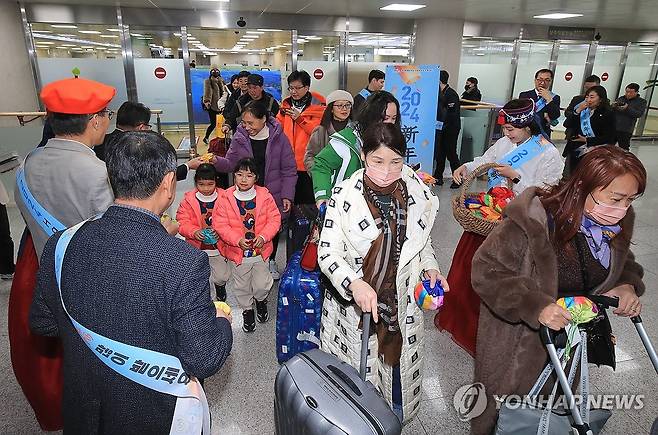 설 연휴 제주 찾은 중국 관광객 (제주=연합뉴스) 박지호 기자 = 설 연휴를 앞둔 8일 오후 제주국제공항 1층 국제선 도착장에서 상하이발 직항기를 타고 온 중국인 관광객을 환영하는 행사가 진행되고 있다. 2024.2.8 jihopark@yna.co.kr