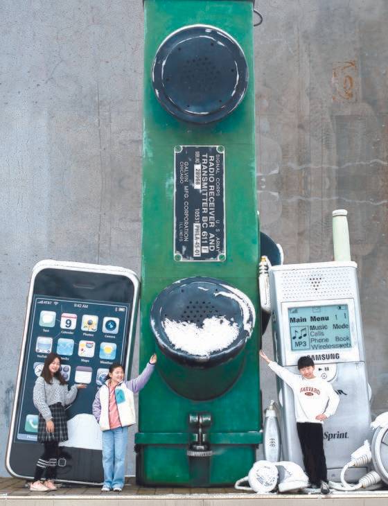 박재인·조유나·유정현(왼쪽부터) 학생기자가 경기도 여주시 여주시립 폰박물관에서 전화기에 대해 알아봤다. 왼쪽부터 스마트폰 ‘아이폰’, 세계 최초 무전기 ‘SCR-536’, MP3 뮤직폰 ‘SPM100 Uprore’.