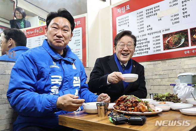 [서울=뉴시스] 김금보 기자 = 이재명(오른쪽) 더불어민주당 대표와 서울 종로 곽상언 후보가 4일 오후 서울 종로구 창신시장을 찾아 족발을 먹고 있다. 2024.03.04. kgb@newsis.com