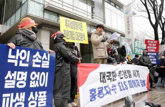 Investors in Hong Kong-linked derivative products hold a rally in front of the Financial Supervisory Service office in western Seoul on Dec. 15 ahead of their imminent maturity. [YONHAP]