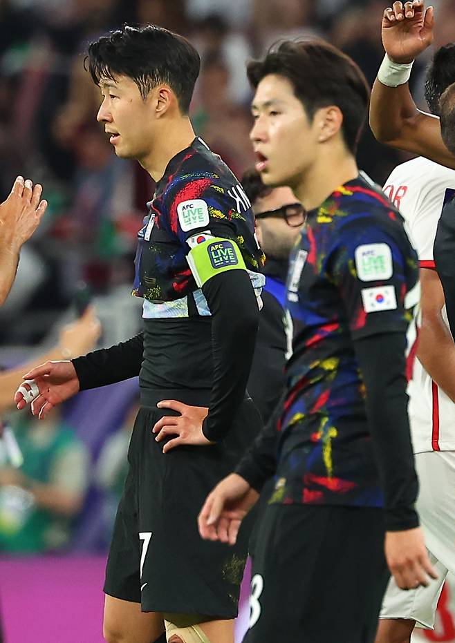 Son Heung-min (left) and Lee Kang-in after South Korea's 2-0 loss to Jordan in the semifinal match at the Asian Football Confederation Asian Cup at Ahmad bin Ali Stadium in Al Rayyan, Qatar on Feb. 6, 2024. (Yonhap)