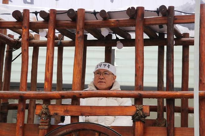 28일 전주을 정운천 국민의힘 후보가 '오직전북'이라는 머리띠를 한 채 함거 안에 앉아있다./김민기 기자