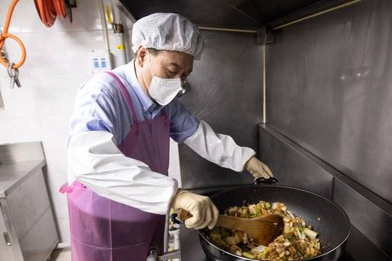 지난 27일 윤석열 대통령이 서울 명동성당의 무료 급식소인 명동밥집에서 돈육김치찌개를 조리하는 모습. 사진 대통령실