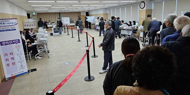 전북 완주군 봉동읍사무소에 차려진 제22대 국회의원선거 사전투표장을 찾은 유권자들이 투표를 위해 줄을 서서 기다리고 있다.