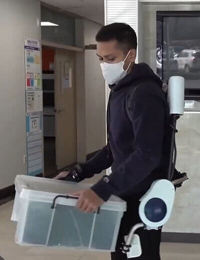 대전 한국과학기술원(KAIST·카이스트)에서 슈브로닐 센굽타(26·박사과정)씨가 외골격(Exoskeleton) 로봇을 입고 물건을 옮기고 있다. 팔이나 다리 등에 장착한 외골격 로봇이 근력을 높여줘 짐을 들고 옮기는 부담을 덜어준다.     센굽타 제공
