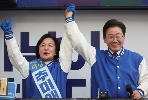 더불어민주당 이재명 대표가 7일 하남시 위례스타필드시티 앞에서 추미애 후보와 손을 맞잡고 있다.  연합뉴스