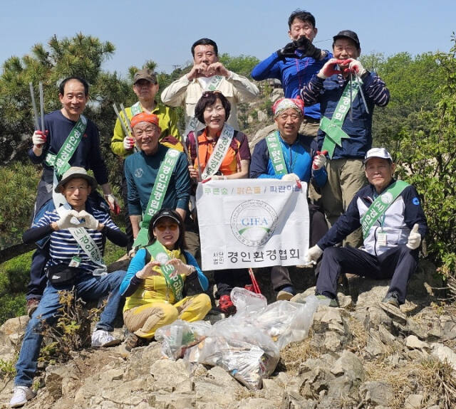 ㈔경인환경협회가 최근 인천 미추홀구 문학산 일대에서 올해 2번째 환경정화 활동을 마치고 기념촬영을 하고 있다. 경인환경협회 제공