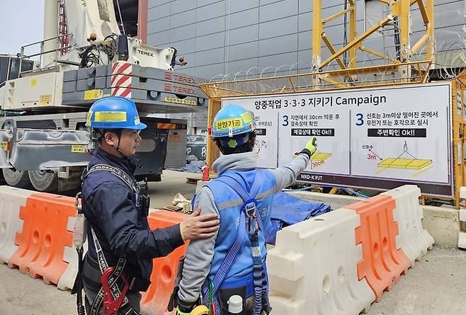 경기도의 한 삼성물산 건축 현장에서 근로자가 작업 중지를 신청한 후 개선 사항에 대해 설명을 듣고 있다. 삼성물산