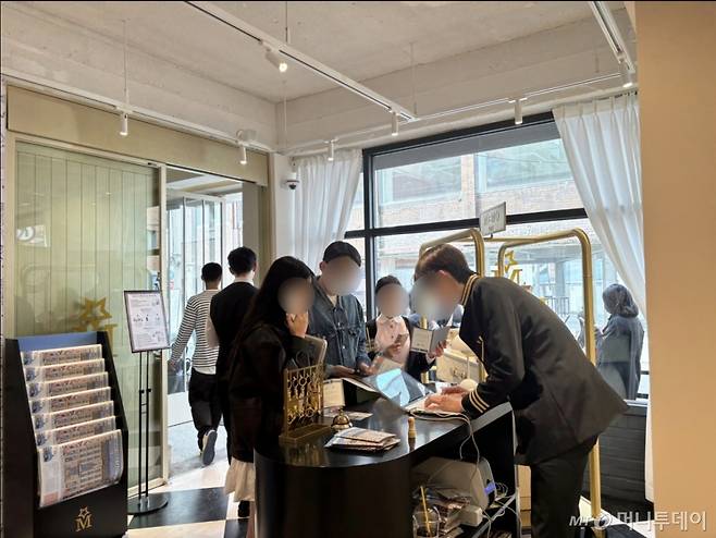 지난 16일 서울 성동구 성수동에 마련된 프랑스 니치향수 브랜드 메모파리 팝업스토어에서 직원이 고객들에게 체크인 카드 발급을 도와주고 있다. /사진=하수민기자