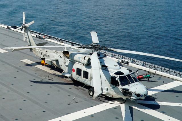 일본 해상 자위대 소속 초계 헬기 SH-60K가 2019년 6월 26일 브루나이 해안에서 운항 중인 헬기 운반선 JS 이즈모(DDH-183) 위에 대기하고 있다. 브루나이=AP 연합뉴스