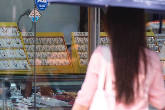 A person passes by the Jongno Jewelry Shopping Street in central Seoul on Tuesday. [YONHAP]