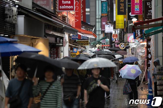 전국 대부분 지역에 비가 내리는 4월15일 오후 서울 중구 명동거리에서 외국인 관광객들이 발걸음을 재촉하고 있다. 2024.4.15/뉴스1 ⓒ News1 이재명 기자