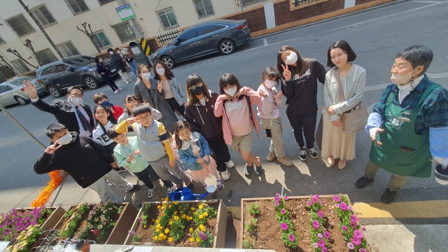 광진교회가 마련한 원예학교에 참여한 어린이들이 지난해 서울 광진구 교회 인근에서 꽃을 가꾸고 있다. 광진교회 제공