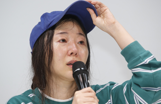 Min Hee-jin, producer of girl group NewJeans and CEO of ADOR, sheds tears during a press conference held on April 25 in southern Seoul. [NEWS1]