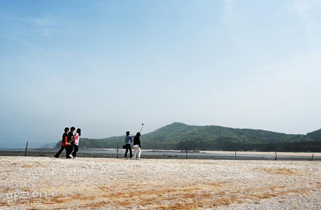 여행객들이 실미도와 연결된 바닷길을 걷고 있다.