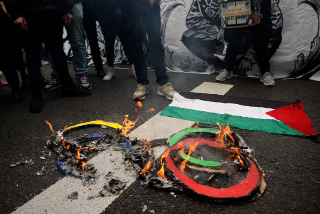 노동절인 1일 시위가 열린 프랑스 파리의 한 거리에 불타고 있는 오륜과 팔레스타인 국기가 보이고 있다. 파리=AP 연합뉴스