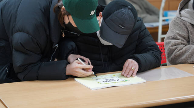 인천 미추홀장애인종합복지관의 ‘바깥서기’ 프로그램에 참여한 한 장애인이 자산관리 노트에 글씨를 쓰고 있다. 인천사서원 제공