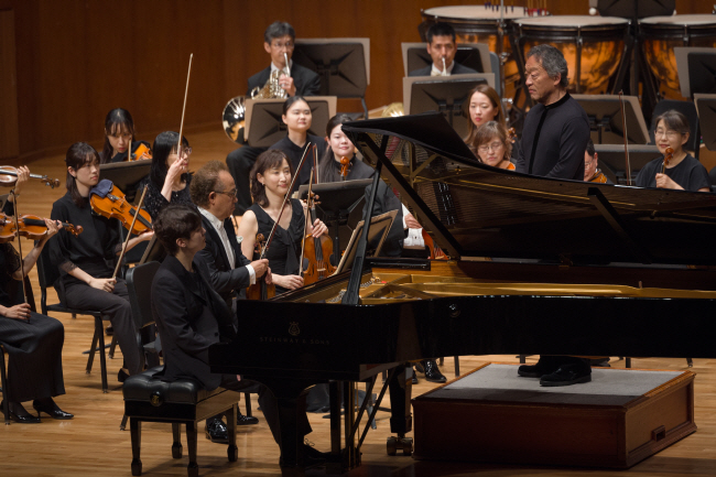 7일 예술의전당 콘서트홀에서 도쿄 필하모닉 오케스트라를 지휘하는 정명훈(오른쪽)과 피아니스트 조성진(왼쪽)이 서로 마주 보며 호흡을 맞추고 있다.  크레디아 제공