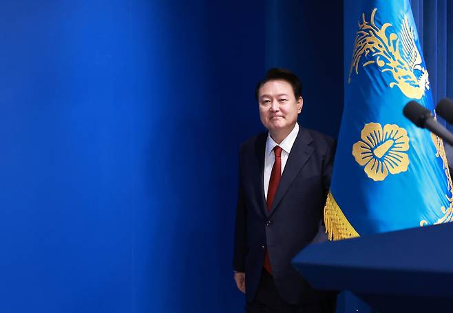 President Yoon Suk Yeol enters the briefing room in his office for a news conference held in Seoul on Thursday. (Yonhap)