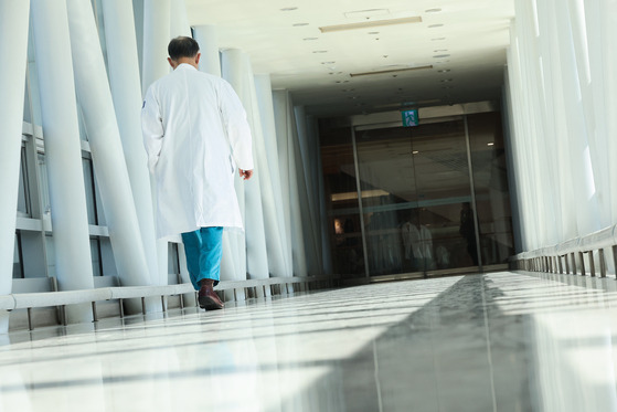 A medical professional walks inside a general hospital in Seoul on Monday. [YONHAP]